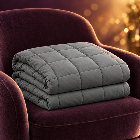 Grey weighted blanket folded on armchair